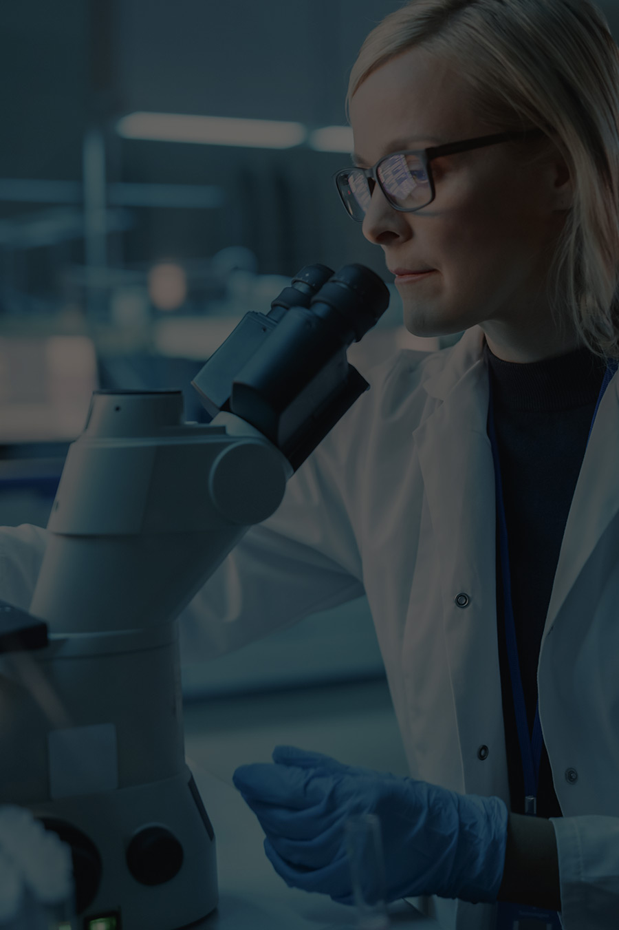 Female using a microscope in a laboratory